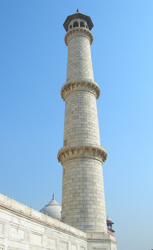 Dramatic perspective of a minaret tower from the platform of the Taj Mahal mausoleum complex in Agra, India