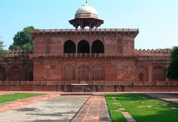 Red sandstone arches and temple near the Taj Mahal mausoleum complex in Agra, India