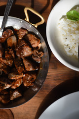 Cooked teriyaki meat food in sauce pan with white rice bowl