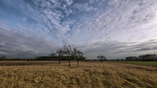 Timelapse clouds moving over the field. Spring landscape footage. 