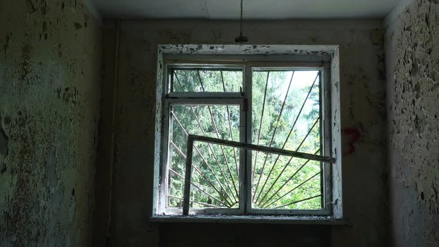 Window in the deserted house. Smooth and slow dolly shot