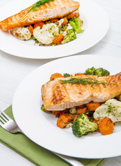 salmon fillet on a bed of broccoli, cauliflower and carrots