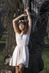 beautiful woman next to a almond tree