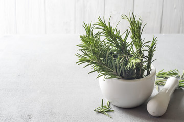 Rosemary in a bowl on a light background