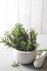 Rosemary in a bowl on a light background