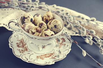 Fototapeta premium Easter concept, black background, quail eggs, pussy willow, vintage style
