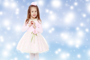 Elegant little girl in a pink dress.