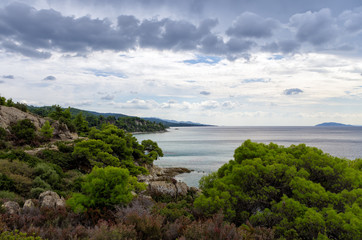 Fototapeta na wymiar Gorgeous scenery by the sea under a cloudy sky in Sithonia, Chalkidiki, Greece 