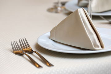 table setting forks on a table in the restaurant.