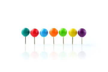 Row of colorful push pins