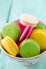macaroons in a bowl on wooden surface