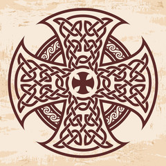 Obraz premium Celtic national ornament in the shape of a cross. Brown drawing with aging effect on a beige background.