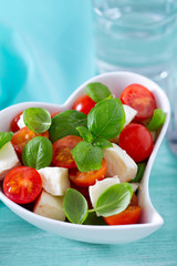 caprese salad in a heart-shaped bowl