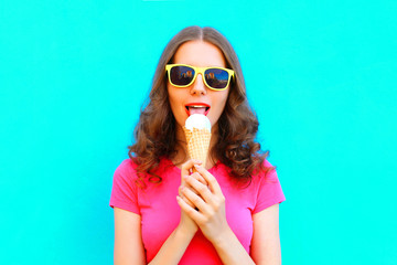 Fashion woman is trying ice cream over colorful blue background
