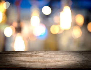 Perspective wooden table for product display montage and abstract lights as background