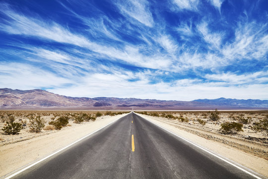 Endless desert road in the Death Valley, travel concept, USA.