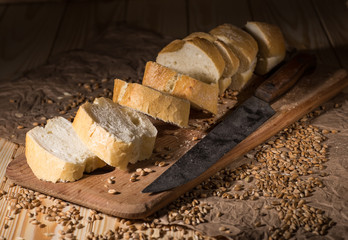 Assortment of baked bread on wooden table background