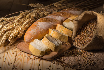 Assortment of baked bread on wooden table background