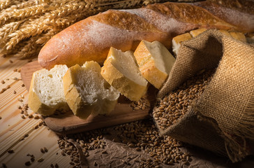 Assortment of baked bread on wooden table background