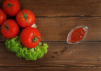 Tomatoes, lettuce and sauce. Top view. The concept of healthy eating and vegetarianism.