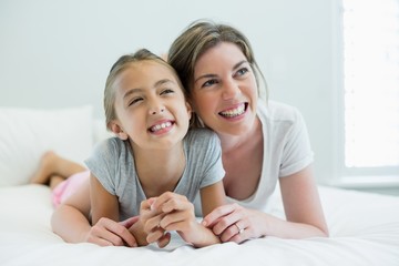 Smiling mother embracing her daughter 