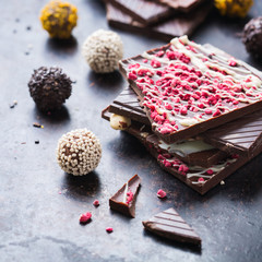 Stack of chocolate bars and praline truffle