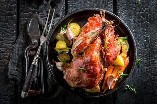 Fresh pheasant with bacon and spices and vegetables