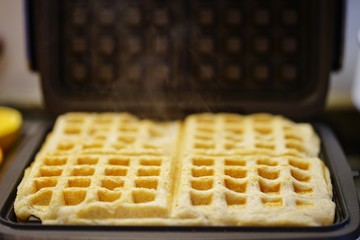 Baking fresh waffles in the waffle-maker