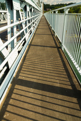 Fototapeta premium Footpath part of deck of the Menai Suspension Bridge over between Anglesey and mainland Wales