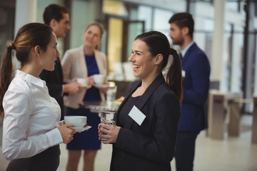 Group of businesspeople interacting with each other in the lobby