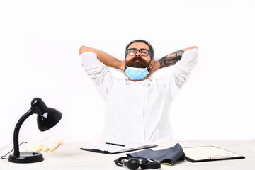 Bearded caucasian doctor sitting at table