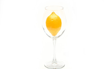Fresh yellow lemon in glass isolated on white background