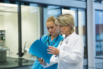 Female doctor and nurse looking at a medical report