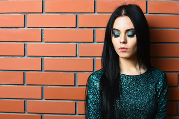 pretty woman with fashionable makeup in green sequins dress