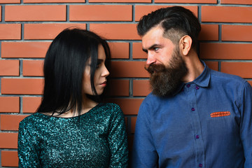 bearded man and pretty sexy woman on brick wall