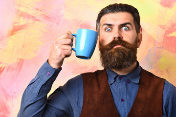 Bearded brutal caucasian hipster with coffee cup