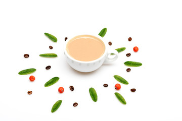 Cup of coffee with milk, coffee leaves, berries and beans