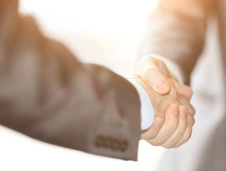 Closeup business hand shake between two colleagues