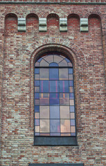glass window with stained-glass windows on the top of the church