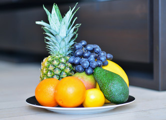 Assortment of exotic fruits on the wooden floor