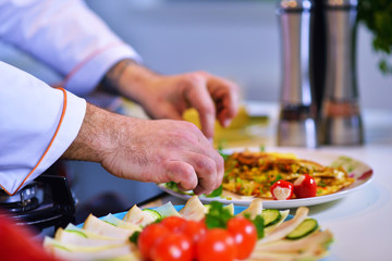 Man's hand holding an egg. White chicken egg. Chef starts preparing omelet.