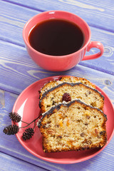 Cup of coffee and fresh baked fruitcake on boards
