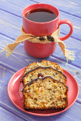 Cup of tea, fresh baked fruitcake on plate