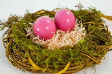 Fototapeta na wymiar Pink Easter eggs in the nest