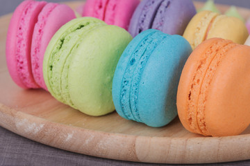 sweet colorful cake macaron in plate on wood table