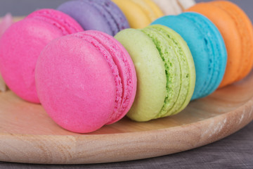 sweet colorful cake macaron in plate on wood table