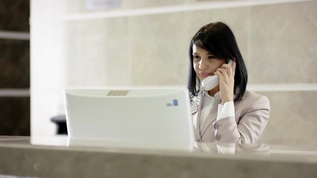Young woman at work as receptionist