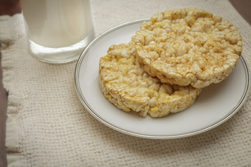 round rice cakes with a glass of ice cold milk
