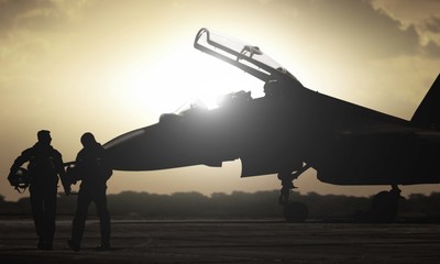 Military aircraft pilot walking during sunset