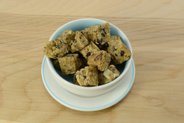 Fruit and Granola bite-size snacks in small bowl with saucer